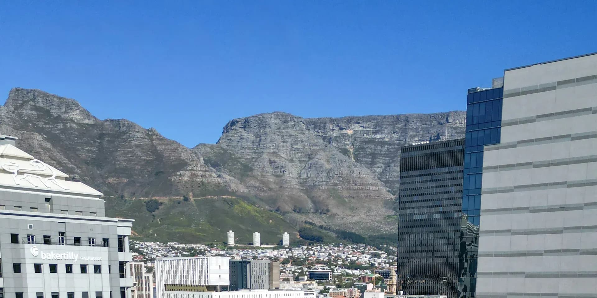 Table Mountain rising behind the Cape Town city centre, seen from Jetty Quarter