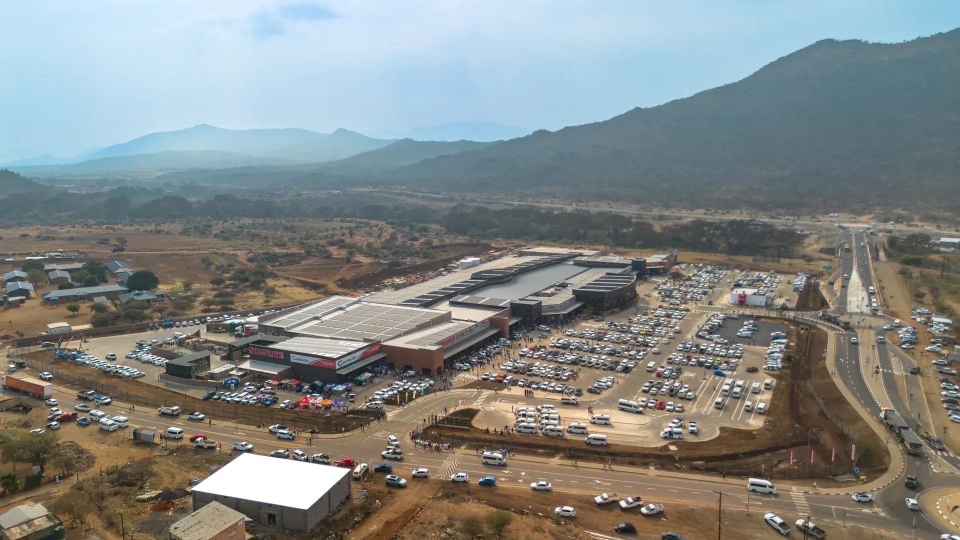 Malekane Mall from above, its parking full on opening week, with the mountains of the greater Tubatse area behind
