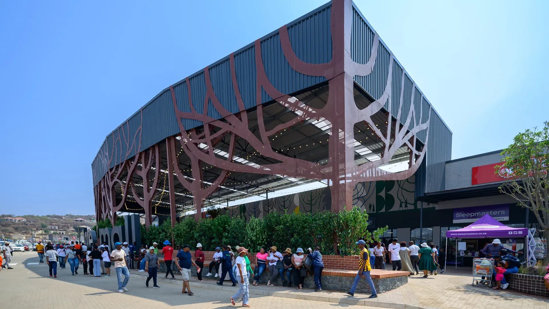 The Malekane Mall entrance court, its steel tree canopy over the planted forecourt